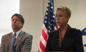 State Auditor Beth Wood describes the results of her audit of the state Medicaid program, while Governor Pat McCrory listens.