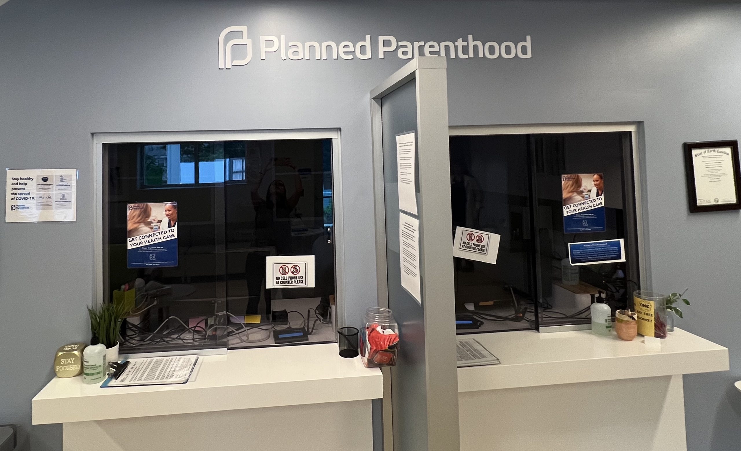 two patient check-in windows in a Planned Parenthood clinic waiting room