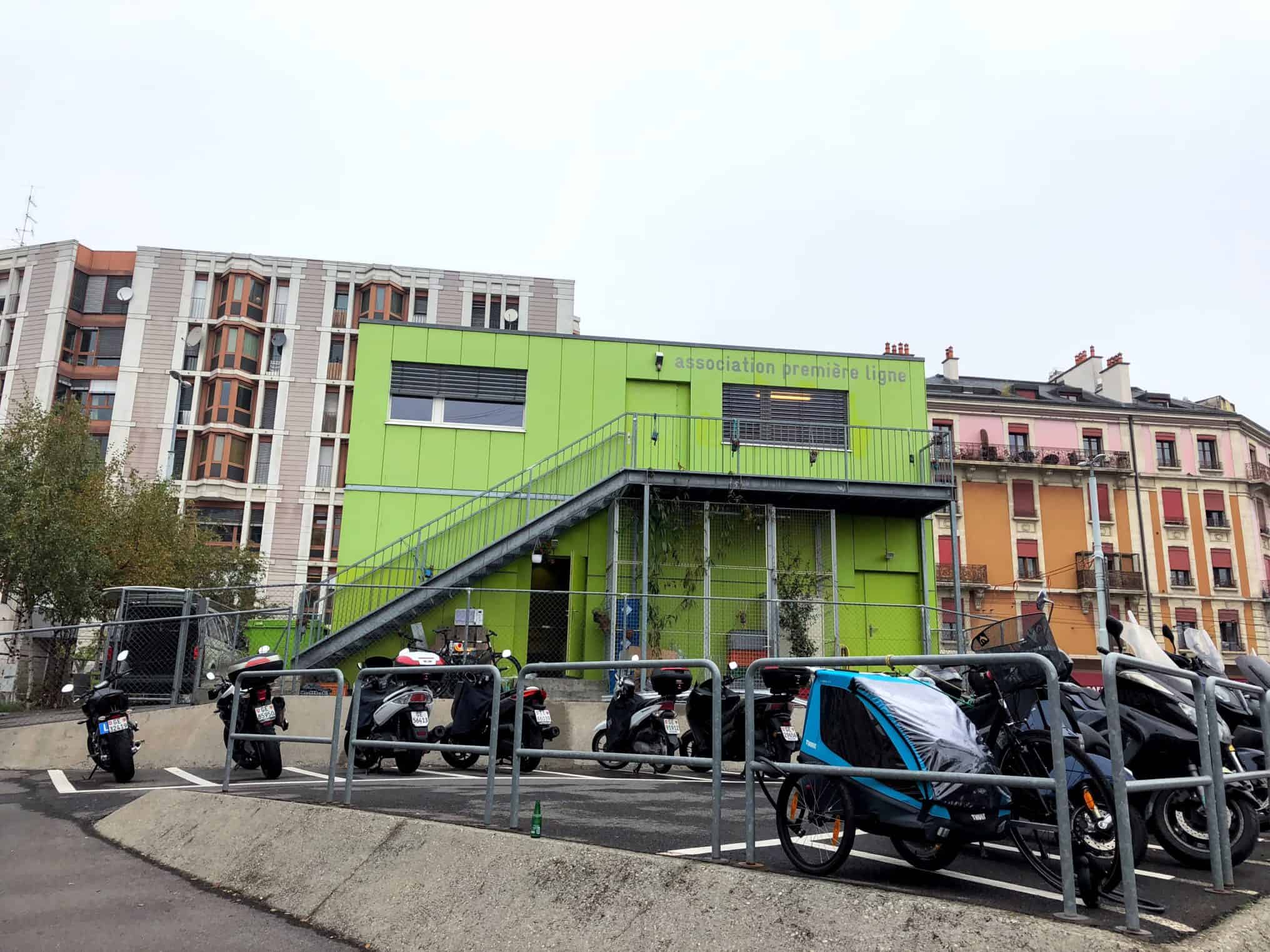 A lime green building with motorcycles in front of it.