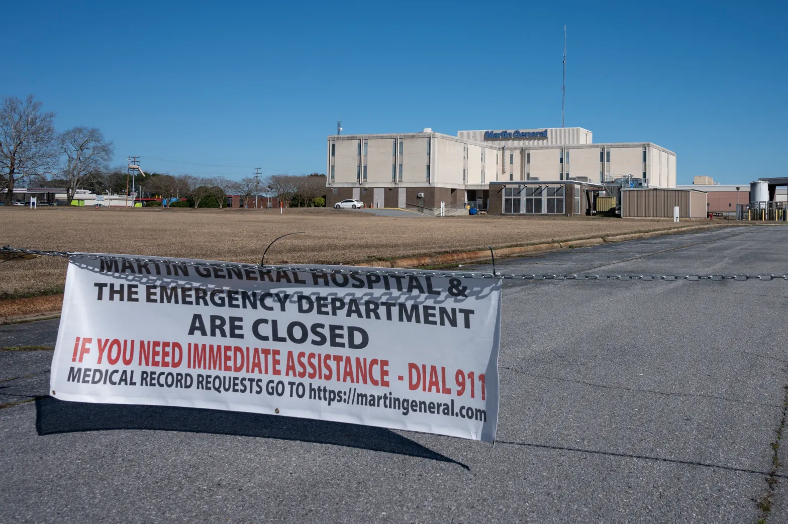 A hospital sits in the distance with a