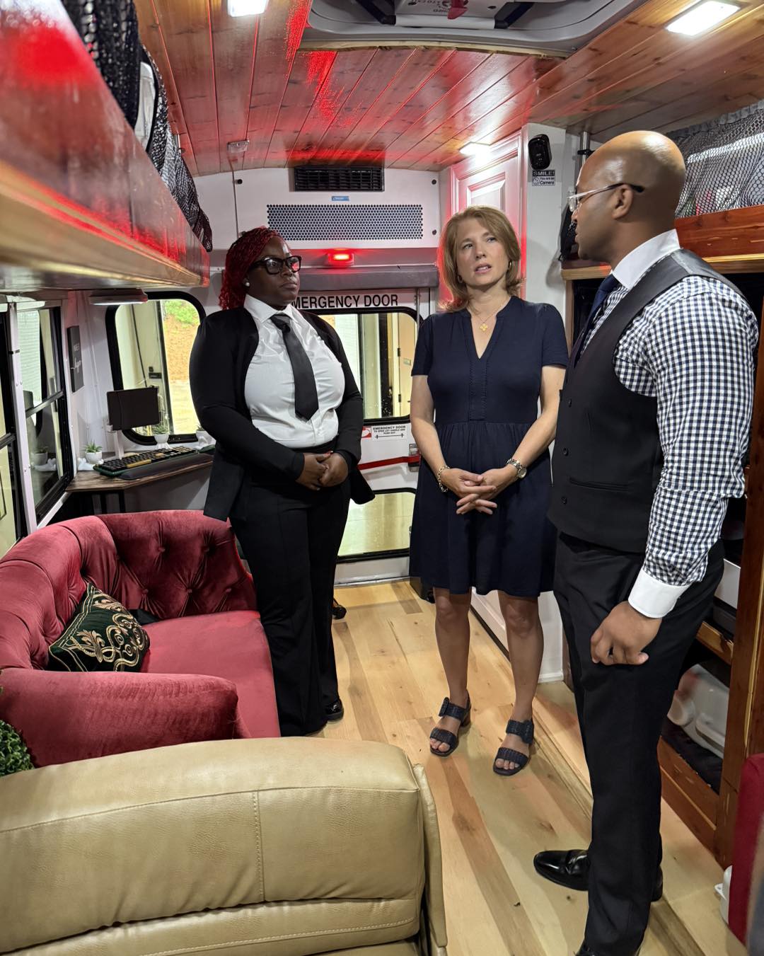 The first lady of North Carolina stands aboard a bus that has been converted into a mobile reentry center supporting formerly incarcerated people
