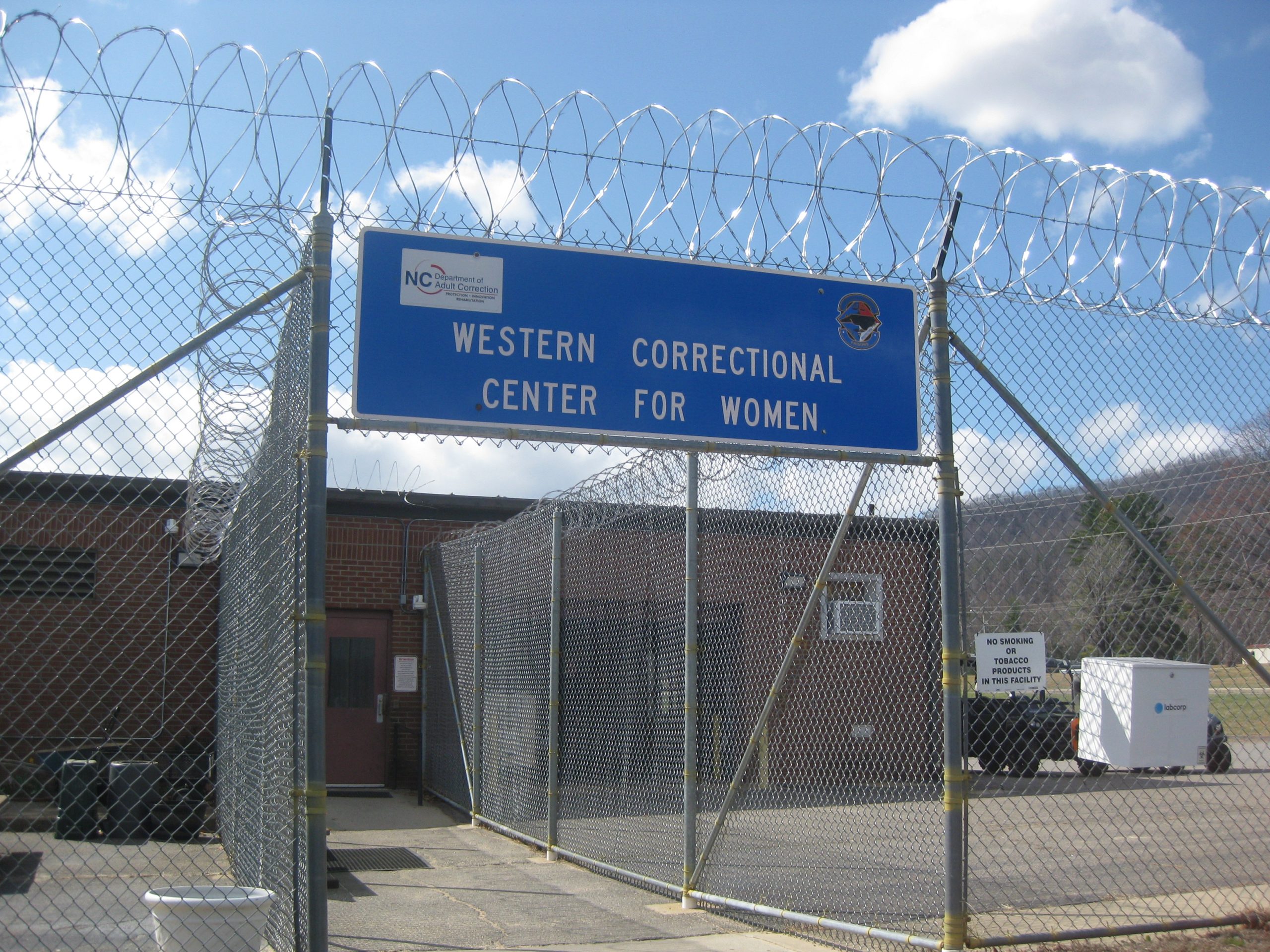 The entrance to a women's prison surrounded by barbed wire