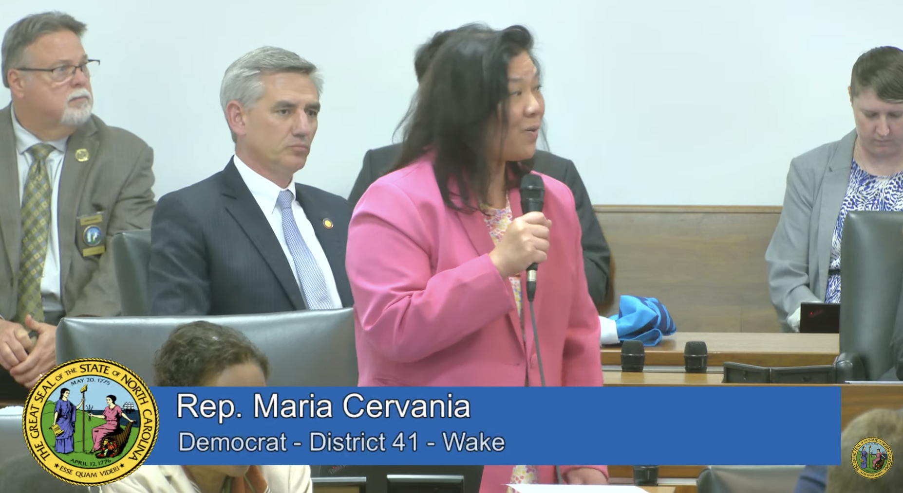 NC lawmaker, Rep. Maria Cervania, dressed in pink jacket speaks about the Medicaid bill on House floor at General Assembly.