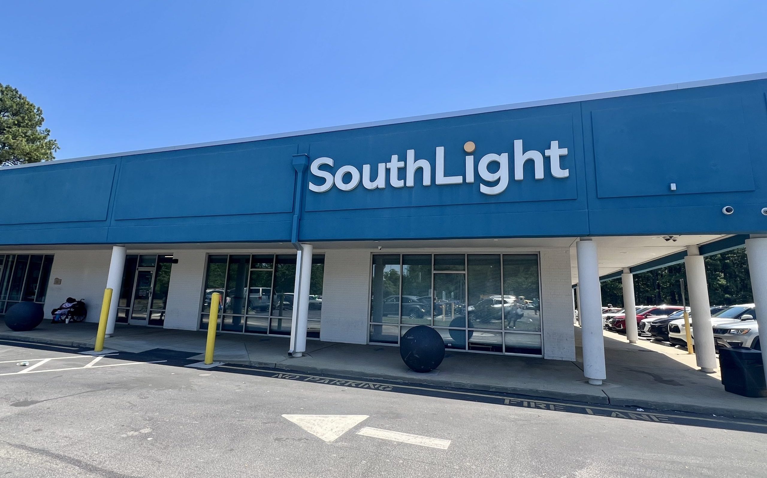 A building with multiple windows. The top of the building is painted blue and signage reads "SouthLight." It is an outpatient mental health and substance use treatment provider.